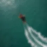 Aerial view of a kitesurfer riding the Naish Hover in crystal-clear waters