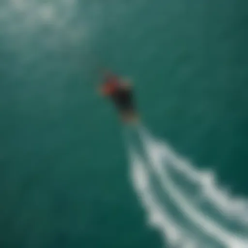 Aerial view of a kitesurfer riding the Naish Hover in crystal-clear waters