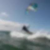 Aerial view of a kitesurfer riding waves with the Ozone Trainer Kite