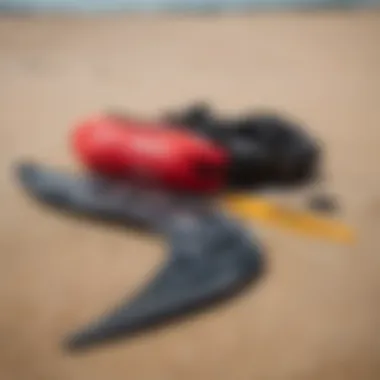 Close-up of kitesurfing gear laid out on the sandy beach