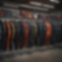 Different types of wetsuits for kitesurfing displayed on a rack