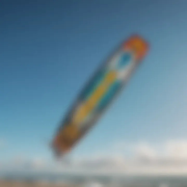 Kitesurfing board with colorful kite against a clear blue sky