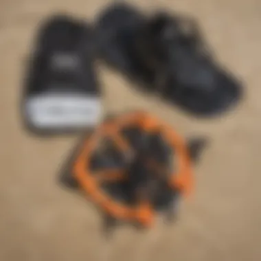 Close-up of Dakine kitesurfing gear laid out on sandy beach