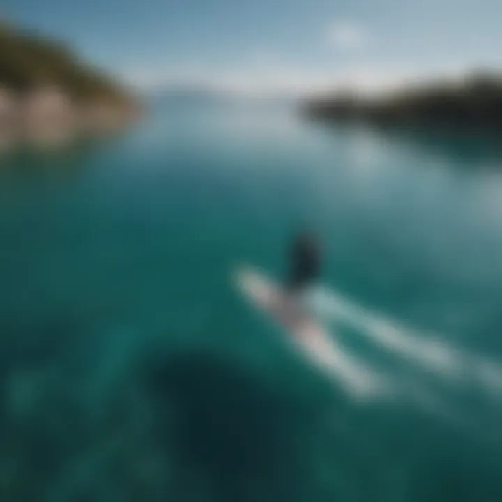 Aerial view of a rider gliding on an efoil over crystal-clear waters