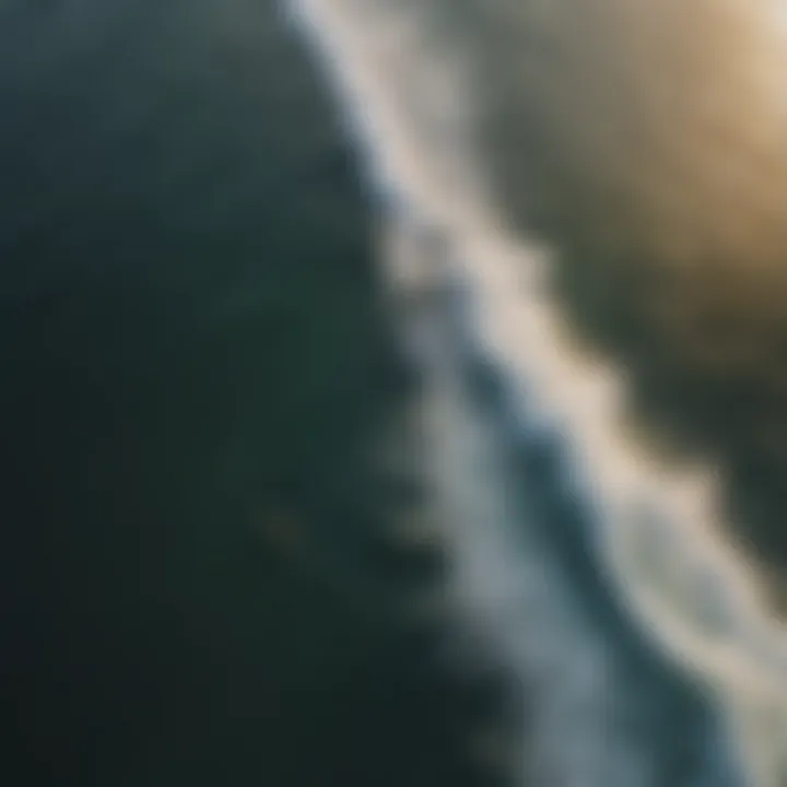 Aerial view of efoil surfer catching waves