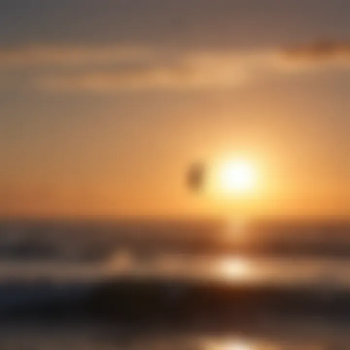 Silhouette of kitesurfer against the setting sun on the horizon