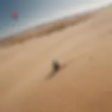 Aerial view of kiteboarding on a sandy dune