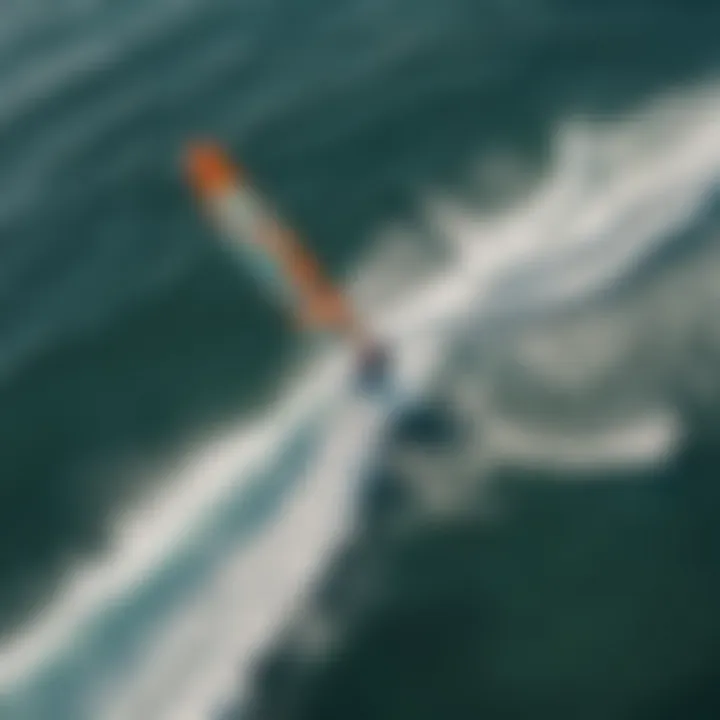 An aerial view of a hydrofoil kiteboarder gliding over the waves.