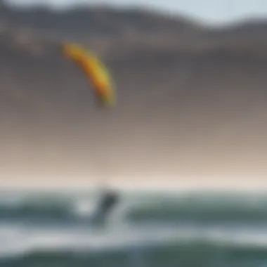 Kitesurfer gliding across the water with vibrant kites in the background against the coastal landscape.