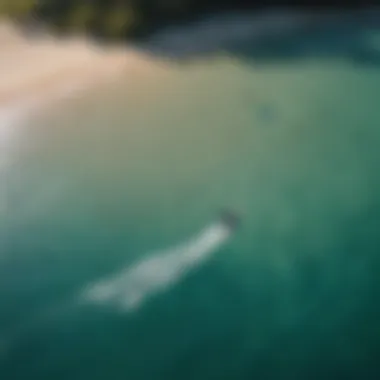 Aerial view of kitesurfers gliding on crystal clear waters