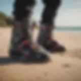 A pair of kitesurf booties on a sandy beach