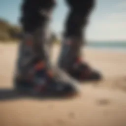 A pair of kitesurf booties on a sandy beach