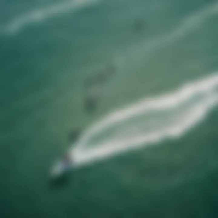 An aerial view of kitesurfers navigating the waves, highlighting the dynamic ocean conditions