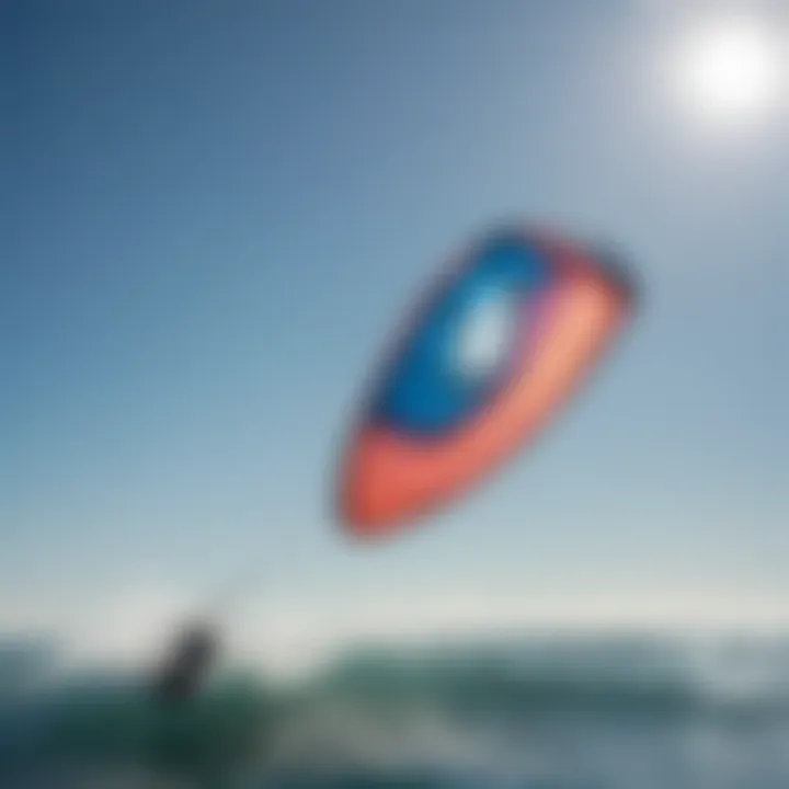 A vibrant Liquid Force Kite soaring through the blue sky