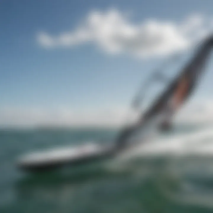 Close-up view of a small hydrofoil attached to a kiteboard, showcasing its sleek design and engineering.