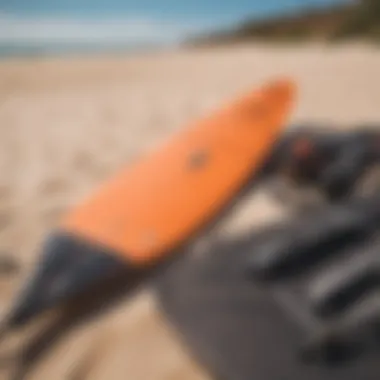 A detailed arrangement of kitesurfing equipment laid out on the sand.