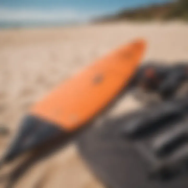 A detailed arrangement of kitesurfing equipment laid out on the sand.