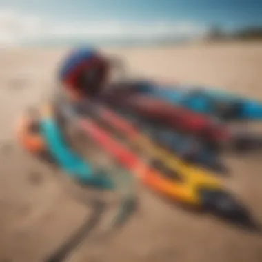 An array of colorful kitesurfing equipment laid out on a sandy beach