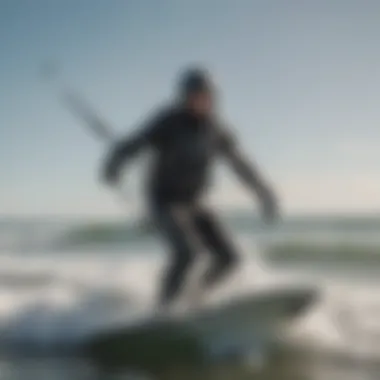 A kitesurfer gliding on waves wearing a drysuit