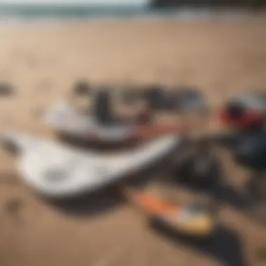 Close-up of essential wing surfing gear laid out on the beach