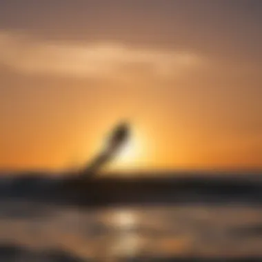 Silhouette of a kiteboarder against a stunning sunset backdrop