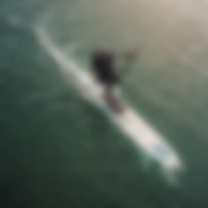 Aerial view of a kitesurfer gliding gracefully on a wing board