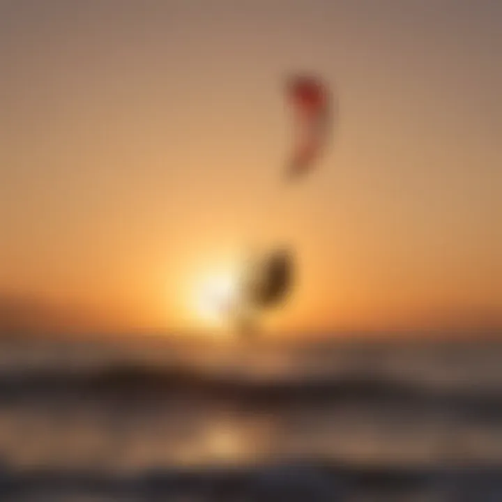 Silhouette of a kitesurfer riding waves at sunset with a majestic kite in the background