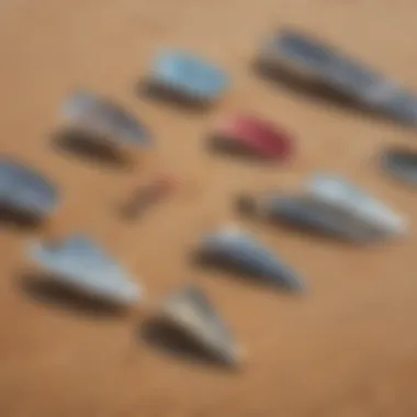 A diverse range of foils displayed on a sandy beach, illustrating various shapes and sizes.