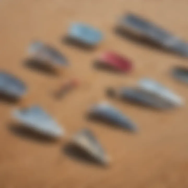 A diverse range of foils displayed on a sandy beach, illustrating various shapes and sizes.