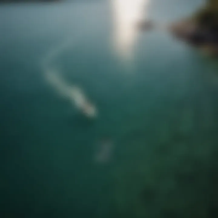 Aerial view of foil boarder cruising through crystal-clear waters under the sun