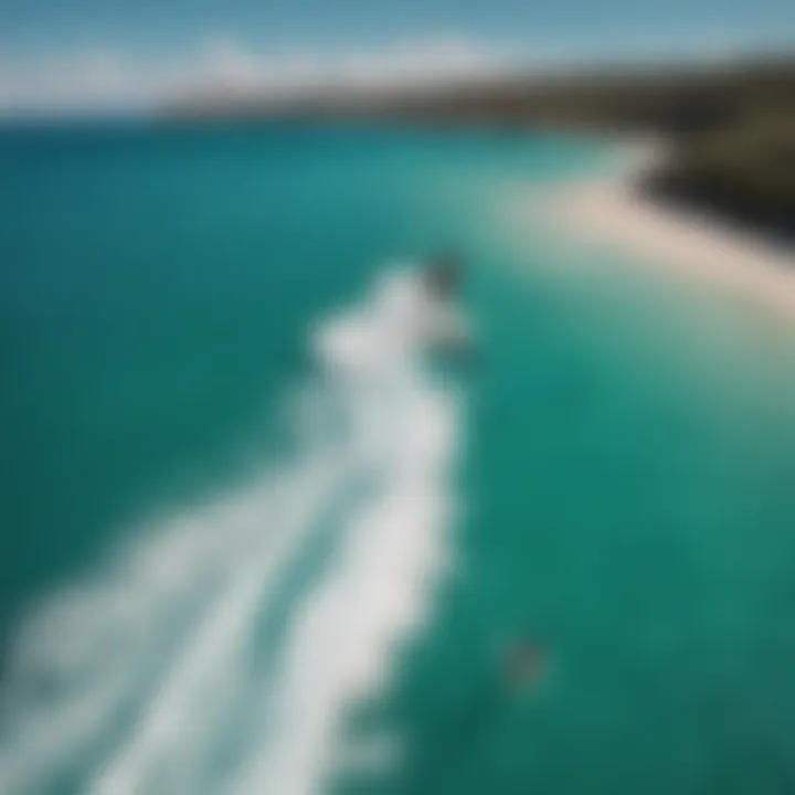 Aerial view of kiteboarder performing advanced tricks on turquoise waters