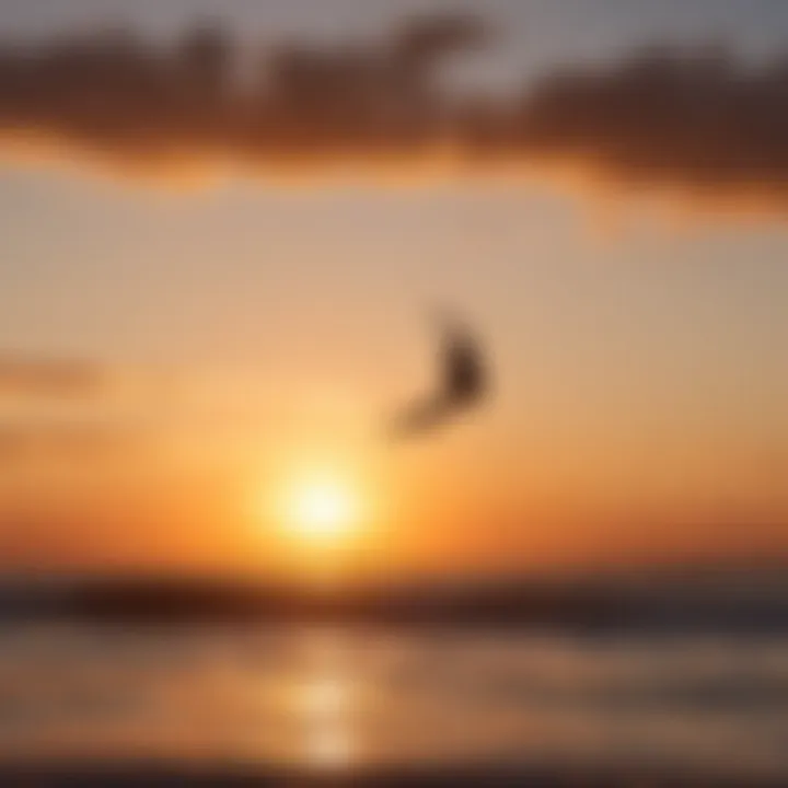 Silhouette of a kiteboarder against a stunning sunset backdrop on the horizon