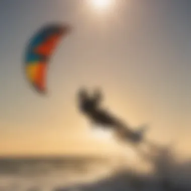 Kitesurfer performing a jump with the sun setting in the background