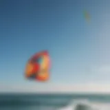 A vibrant HQ sport kite soaring in a clear blue sky