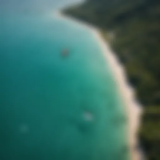 Aerial view of a kiteboarder performing tricks on turquoise waters