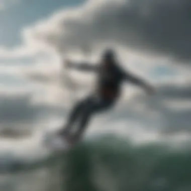 Dramatic shot of a kiteboarder riding waves under a cloudy sky