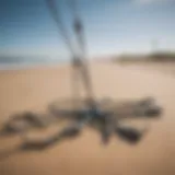 Variety of kite anchors displayed on a sandy beach