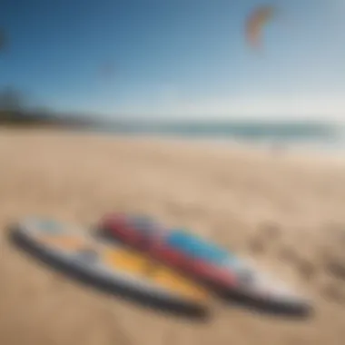 Close-up of kites and boards arranged on the sandy beach ready for kitesurfing