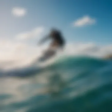 Kiteboarder gliding through the waves under a clear blue sky on Cat Island