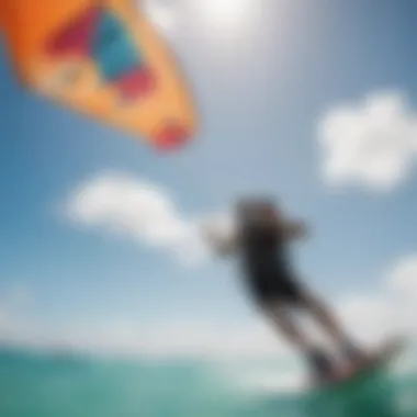 Vibrant kiteboarding scene in Aruba showcasing colorful kites against a clear blue sky.