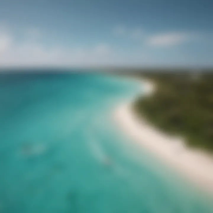 An aerial view of kiteboarders gliding over clear turquoise waters