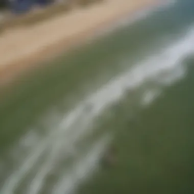 An aerial view of kiteboarders navigating the waves and winds of a popular Michigan beach.