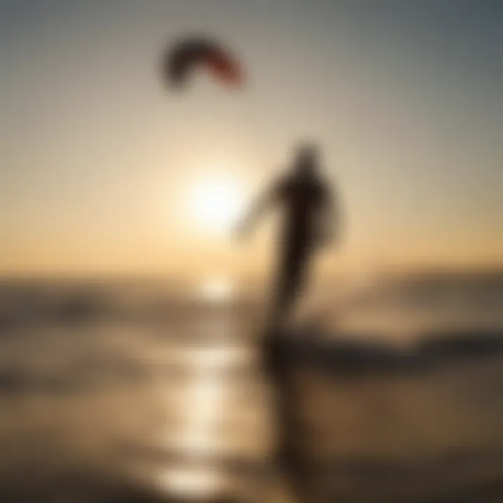 Silhouette of a kiteboarder against a setting sun