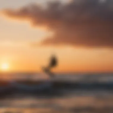 Silhouette of kitesurfer riding the waves during sunset