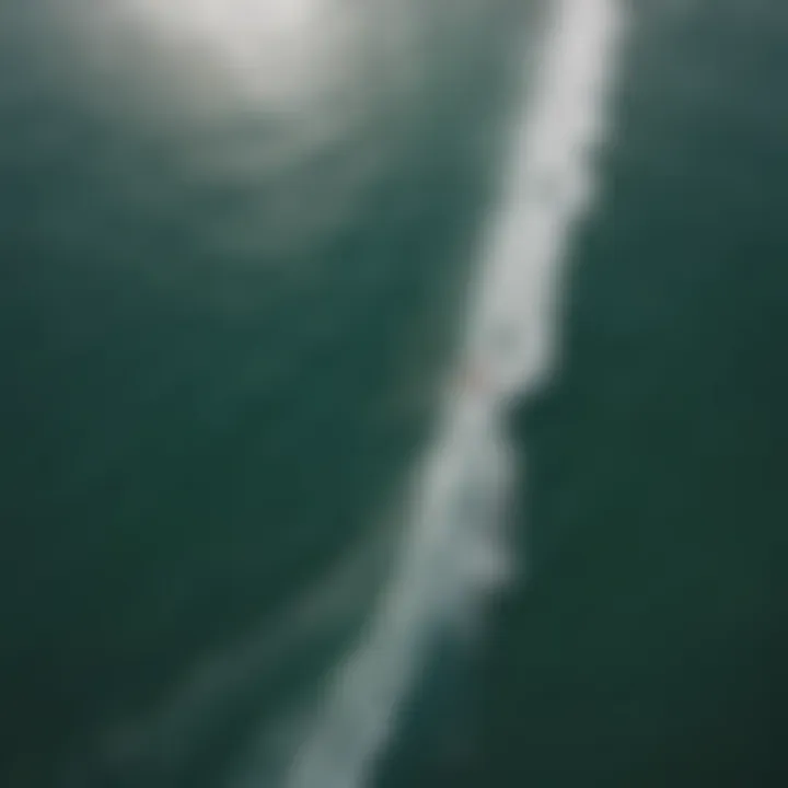 An aerial view of kitesurfers navigating the waves, highlighting the natural beauty of the Philippine coastline