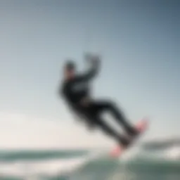 A kitesurfer performing a stylish jump over the crest of a wave