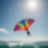 A colorful kitesurfing kite soaring in the clear blue sky