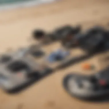 Kiteboarding equipment laid out on a sandy beach