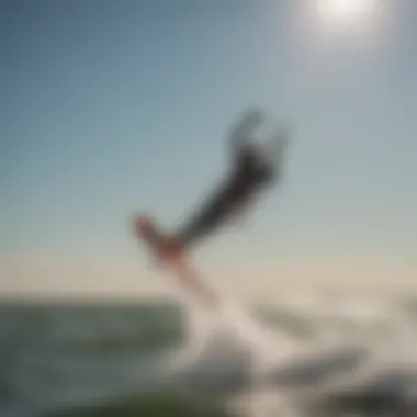 Kitesurfer performing tricks under a clear sky on Lake Erie