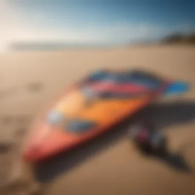 Close-up of colorful kite surfing gear laid out on a sandy beach